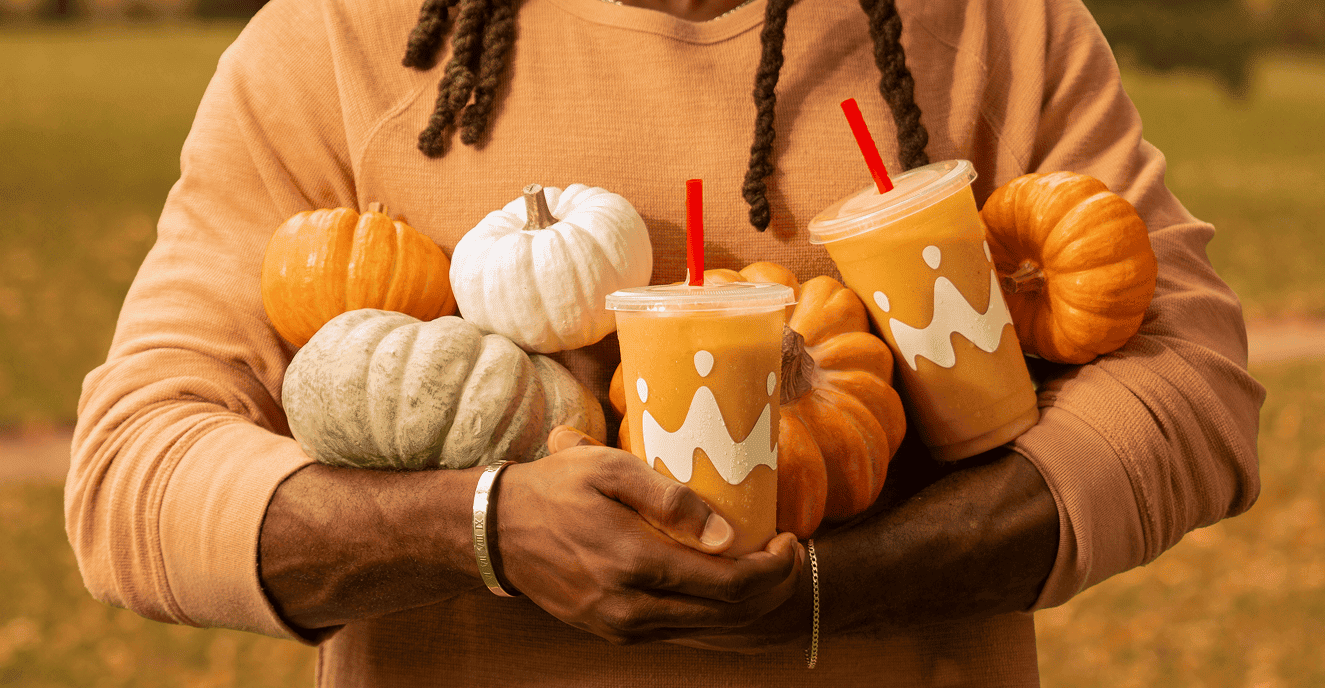 Person with smoothies and pumpkins