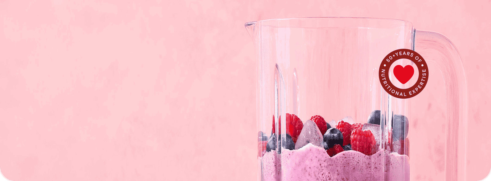 Blender with smoothie and berries