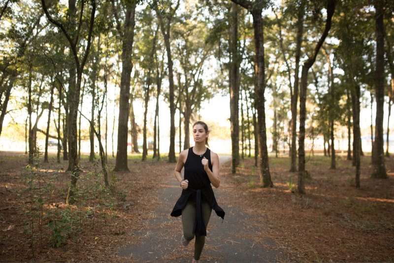 Woman running in park during the fall
